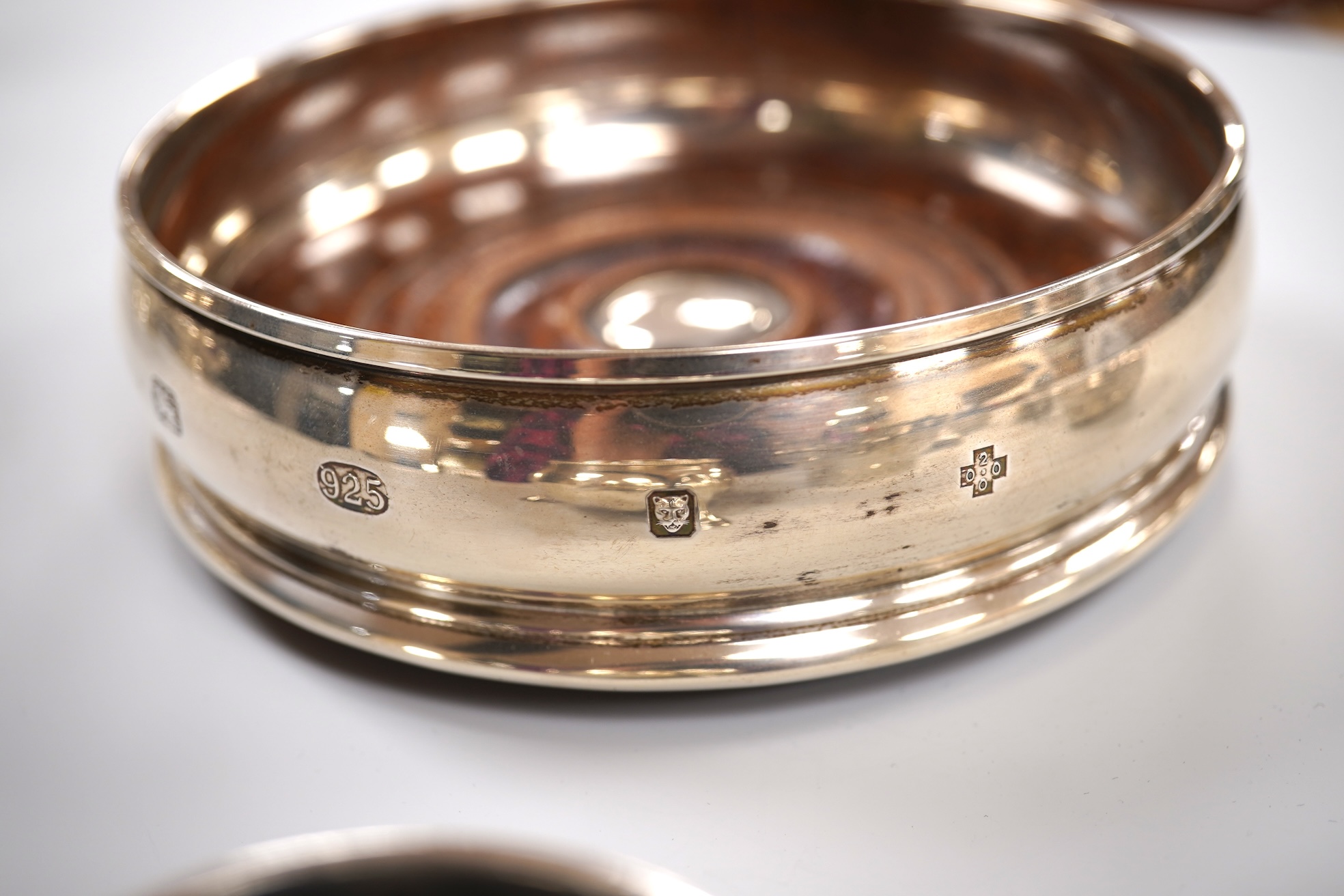 A group of small silver including a modern mounted wine coaster by M C Hersey & Son Ltd, diameter 12.6cm, a set of three George V nut dishes, one other silver nut dish, two pairs of salts including cauldron by William Hu